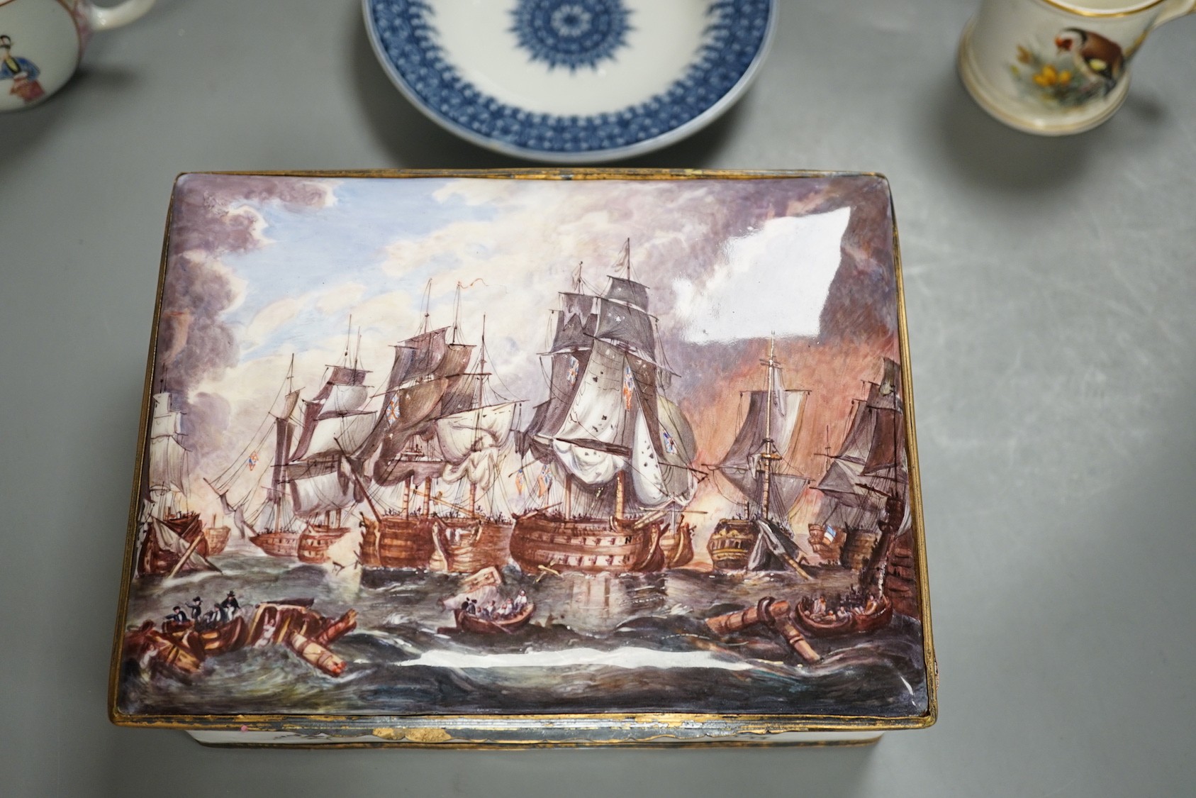 A 19th century enamel on copper trinket box, depicting a shipping fleet, together with a Chamberlain’s Worcester bird plate, a Royal Worcester coffee cup, a Meissen tea cup and three Chinese export cups (9)
